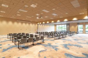 an empty conference room with chairs and a wall of windows at Thon Hotel Drammen in Drammen