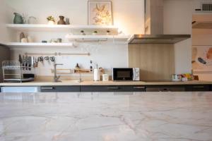 a kitchen with a sink and a counter top at Surin Park by Destada in Surin Beach