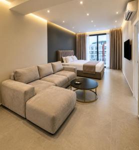 a living room with a couch and a bed at Grand Clochē in Ulcinj