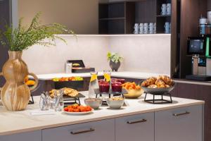 a buffet of food on a table in a kitchen at Thon Hotel Drammen in Drammen +33 photos