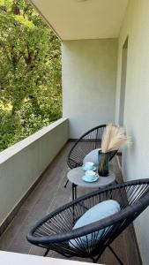 a patio with two chairs and a table on a balcony at Apartmani Asovic in Budva