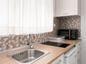 a kitchen with a sink and a microwave at Villa Amy in Achladies +58 photos