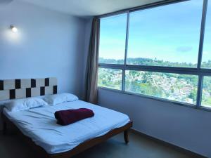 a bedroom with a bed and a large window at VISHAKA RESIDENCY yercaud in Siddhma