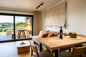 a dining room with a table and a couch at Liostasi Country Houses in Palekastron