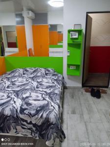 a bedroom with a bed and a green wall at Гостинка in Kharkiv