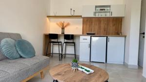 a living room with a couch and a table at Apartmani Asovic in Budva +9 photos
