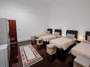 a group of four beds in a room at D'Monochrome in Singapore