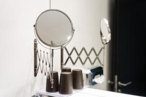 a mirror sitting on a shelf in a bathroom at MICE Collection Hotel Trier Business- und Stadthotel an der Mosel nahe SWT Arena und Viking Anleger in Trier