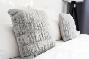 two white pillows sitting on a white bed at MICE Collection Hotel Trier Business- und Stadthotel an der Mosel nahe SWT Arena und Viking Anleger in Trier