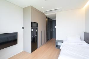 a bedroom with a bed and a tv in a room at Celib Yeoui in Seoul