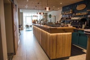 a bar with a wooden counter in a restaurant at Markthotel Warendorf in Warendorf