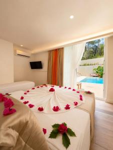a bedroom with two beds with red flowers on them at Doc's Boutique Hotel Kemer in Kemer +90 photos