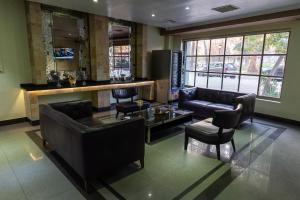 a lobby with couches and a bar in a building at Infinity Park Hotel in Santiago +75 photos