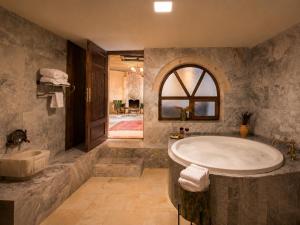 a large bathroom with a tub and a sink at Premium Cappadocia in Göreme +66 photos