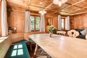 a dining room with a large wooden table and chairs at Ferienhaus Victoria in Schruns