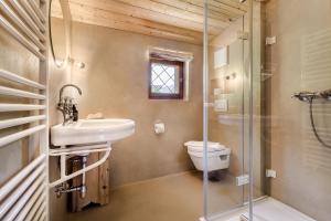a bathroom with a toilet and a sink and a shower at Ferienhaus Victoria in Schruns +30 photos