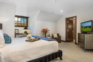 a bedroom with a large bed and a television at 406 The Ascent in Avon +62 photos
