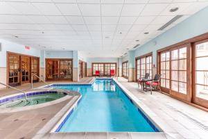 a pool in a large room with a large ceiling at 406 The Ascent in Avon