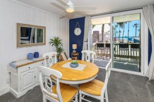 a dining room with a table and chairs and a balcony at D4 - Lighthouse on the Shore in Oceanside