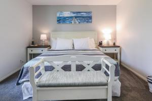 a bedroom with a white bed with two night stands at D4 - Lighthouse on the Shore in Oceanside +54 photos