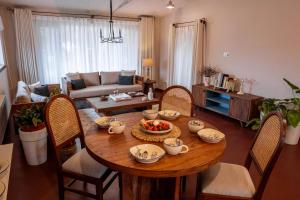 a living room with a wooden table and chairs at Garden Studio in Pātan