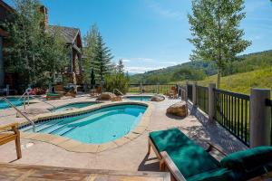 a swimming pool in a yard next to a house at 205 Bear Paw Lodge in Avon