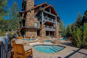 a large house with two pools in front of it at 205 Bear Paw Lodge in Avon