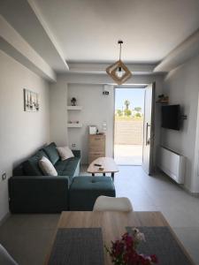 a living room with a couch and a table at Salt & Light House in Tigaki