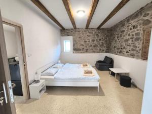 a bedroom with a bed and a couch and a table at Ubytovanie u richtára in Čekovce