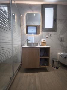 a bathroom with a sink and a mirror and a tub at Salt & Light House in Tigaki +60 photos