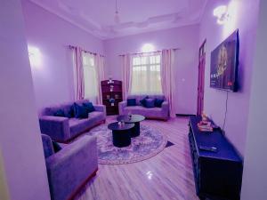 a living room with two couches and a table at Sastar Homes in Iringa