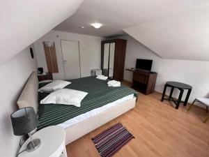a bedroom with a large bed and a desk at Motel Valea Zanelor in Covasna