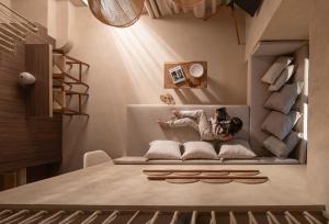 a woman is lying on a couch in a room at Domus Gaia Suites in Nikiti +22 photos
