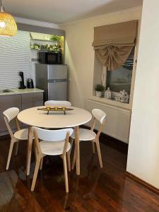 a kitchen with a table and chairs in a room at Maria's Studios Rent Peplos in Péplos