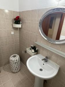 a bathroom with a sink and a mirror at Maria's Studios Rent Peplos in Péplos +20 photos