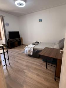 a bedroom with a bed and a wooden floor at Sa Domitta due Alghero in Alghero
