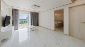 a large white room with a large window and white floors at Ganghwa Glory Bada Pension in Incheon