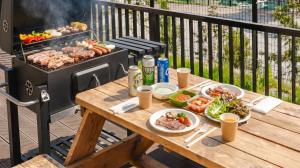 a table with plates of food on a grill at Ganghwa Glory Bada Pension in Incheon