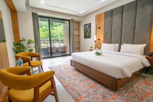 a bedroom with a large bed and a chair at Luxus Naran in Naran +54 photos