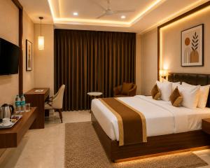 a hotel room with a bed and a desk at VITS Satyajeet Karad in Karād