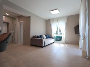 a living room with a couch and a window at Airport Split in Kastel Stafilic