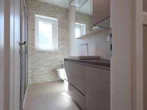 a bathroom with a sink and a toilet and a window at Airport Split in Kastel Stafilic +16 photos