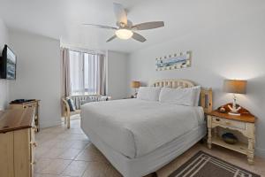 a bedroom with a bed and a ceiling fan at D20 - Beachfront Delight in Oceanside +48 photos