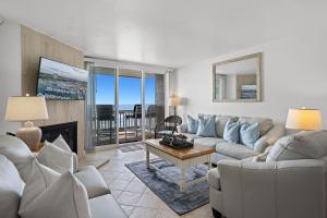 a living room with a couch and a table at D20 - Beachfront Delight in Oceanside