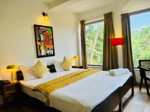 a bedroom with a large bed and a window at HALF Hotel, Calangute in Calangute