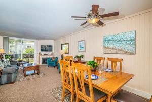 a dining room and living room with a table and chairs at G218 - Palms Away in Oceanside