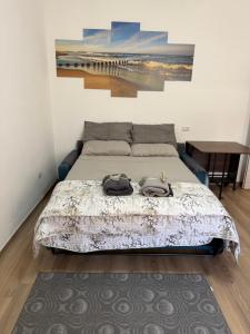 a bedroom with a bed with two bags on it at Sa Domitta due Alghero in Alghero
