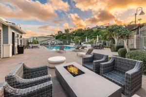 a patio with two couches and a fire pit at Sea Glass Villa in Oceanside