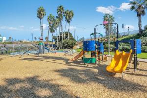 a playground at a park with slides and swings at Sea Glass Villa in Oceanside
