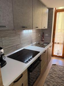 a kitchen with a sink and a counter top at Sa Domitta due Alghero in Alghero